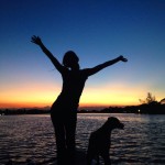a girl and her dog silhouette sunset • Waterfront Properties Blog