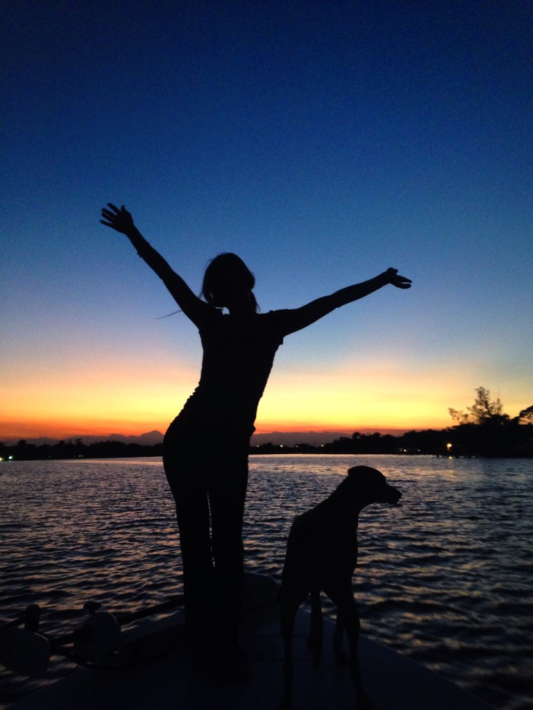 a girl and her dog silhouette sunset • Waterfront Properties Blog